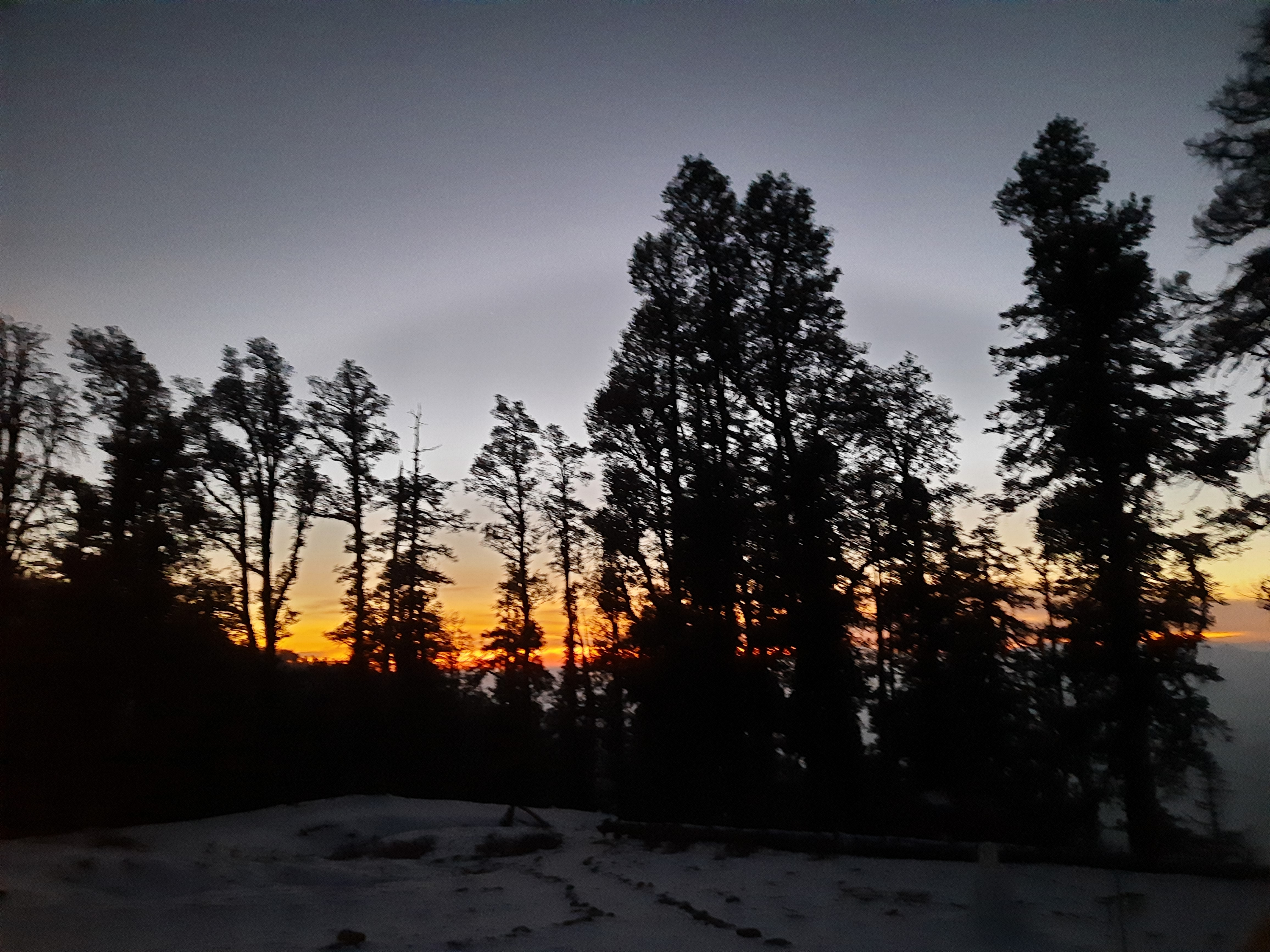 Panoramic view from the summit of Kedarkantha, showing the vast Himalayan landscape.