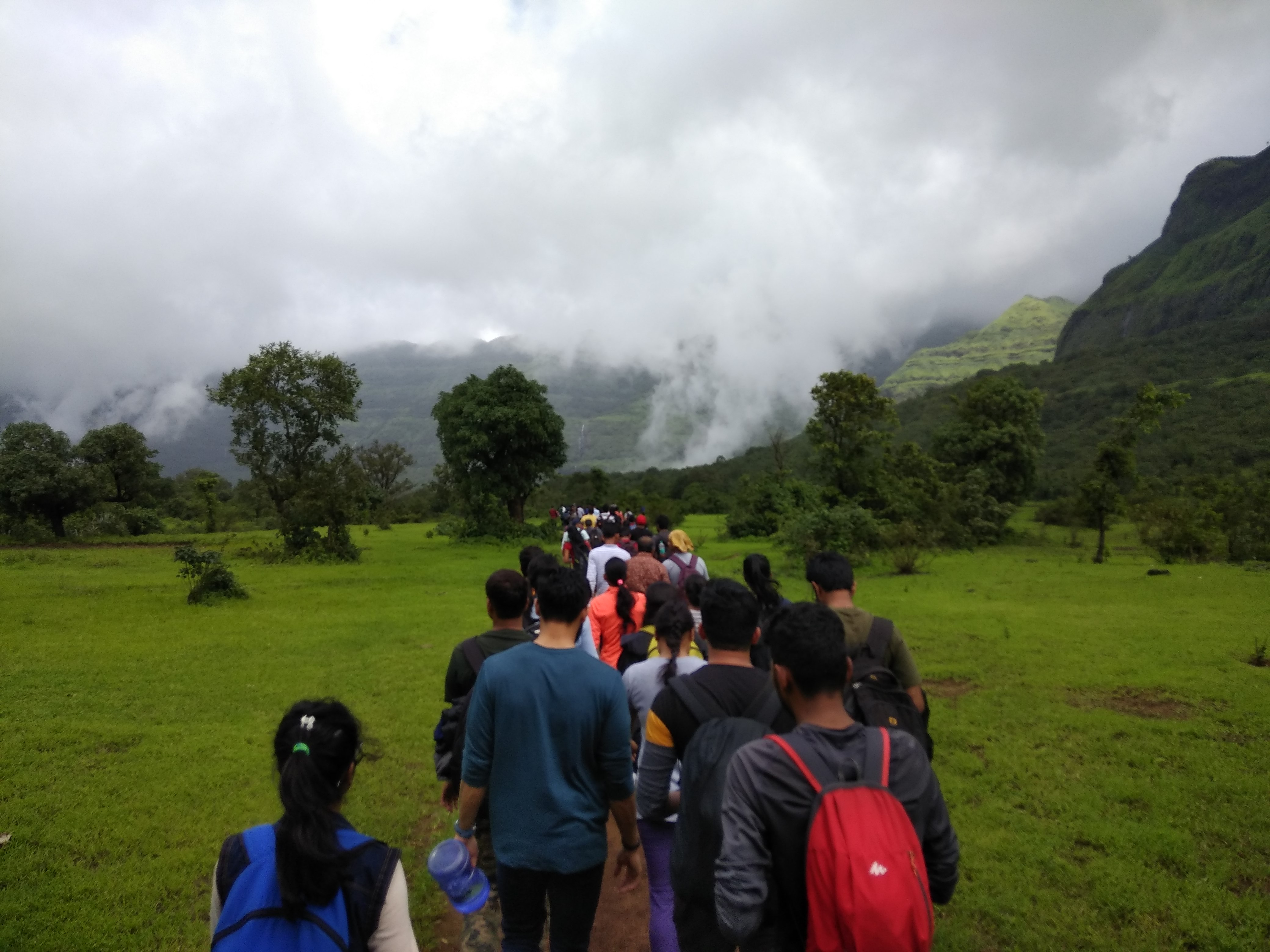 Climbers making their way up a snow-covered ridge towards the andarban summit.