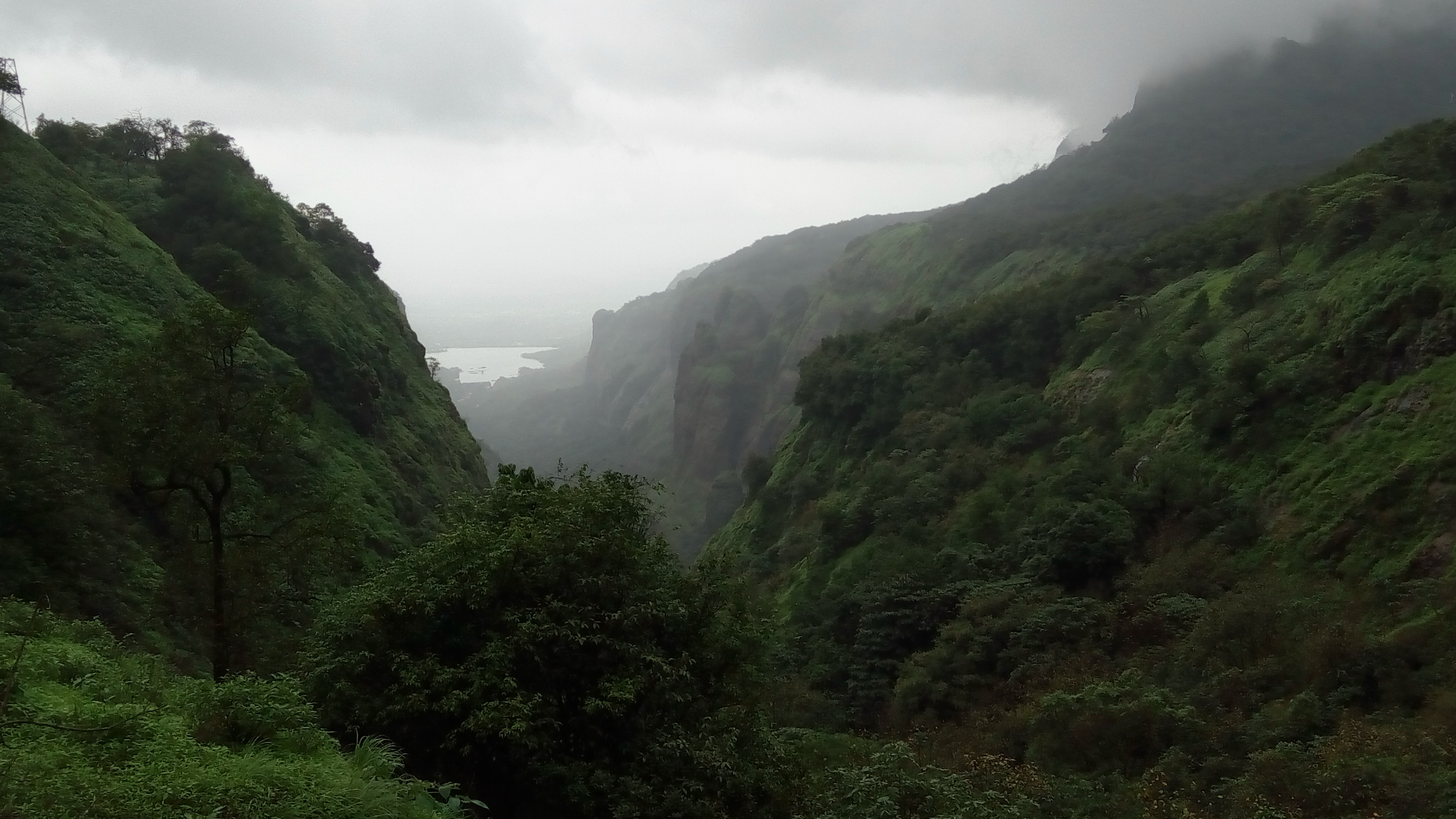 A tent at the andarban base camp with prayer flags and the peak in the background.