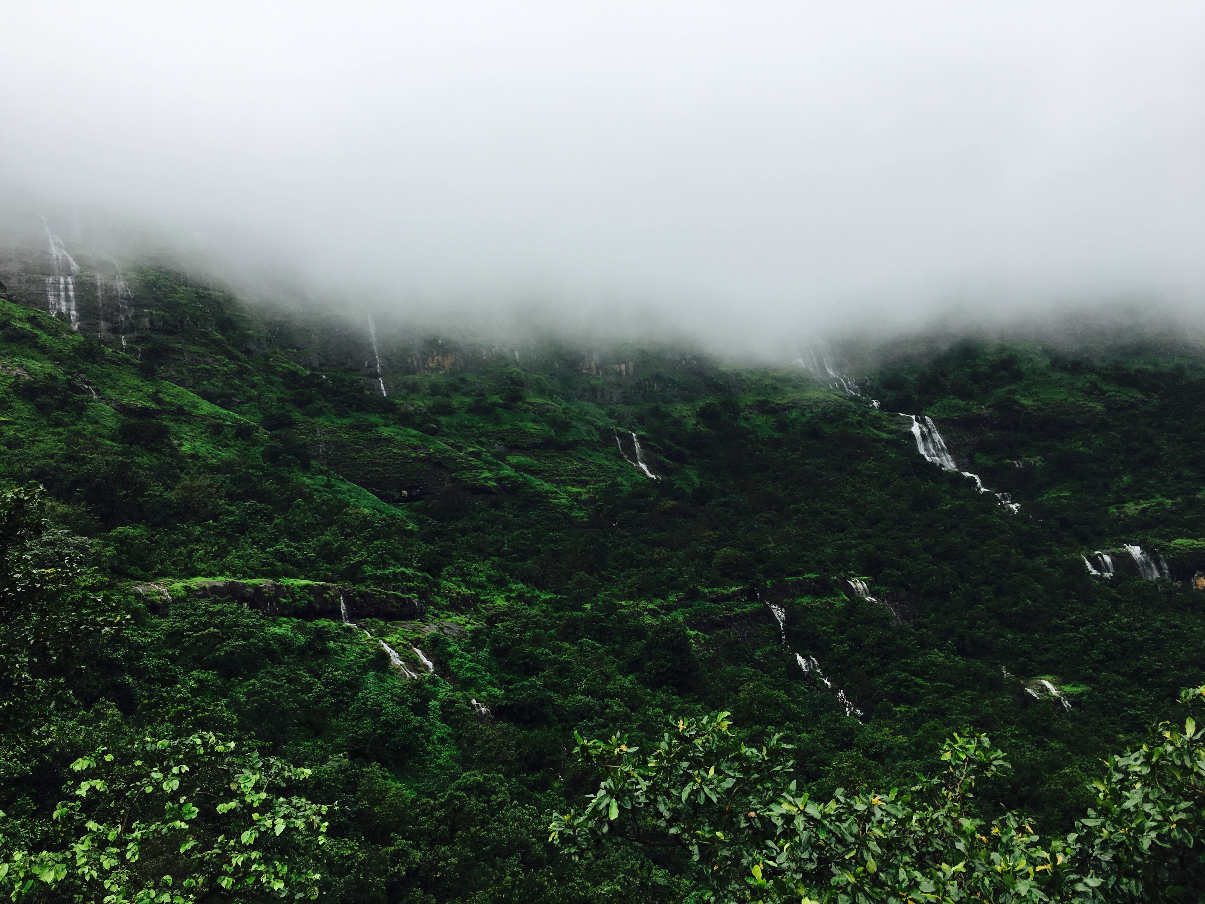 A night trekker's view of the starry sky over the Kalsubai peak.