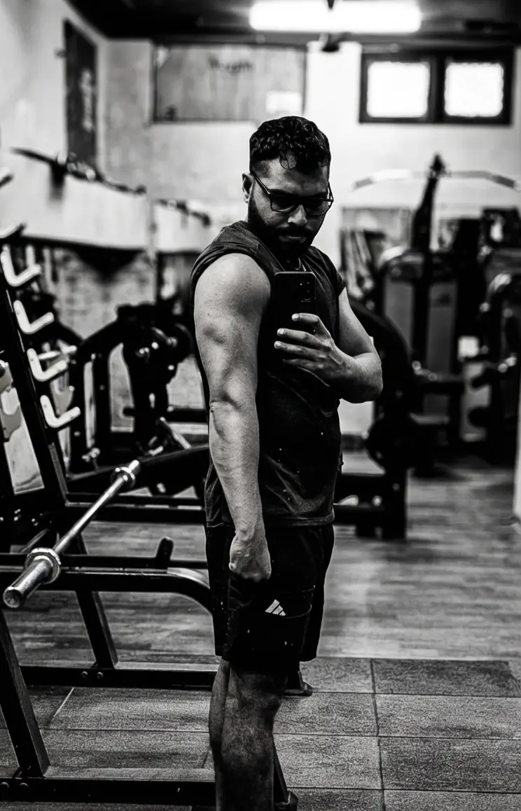 A serene campsite scene at high altitude, with tents pitched beside a rocky valley as clouds roll in over distant snow-covered peaks.