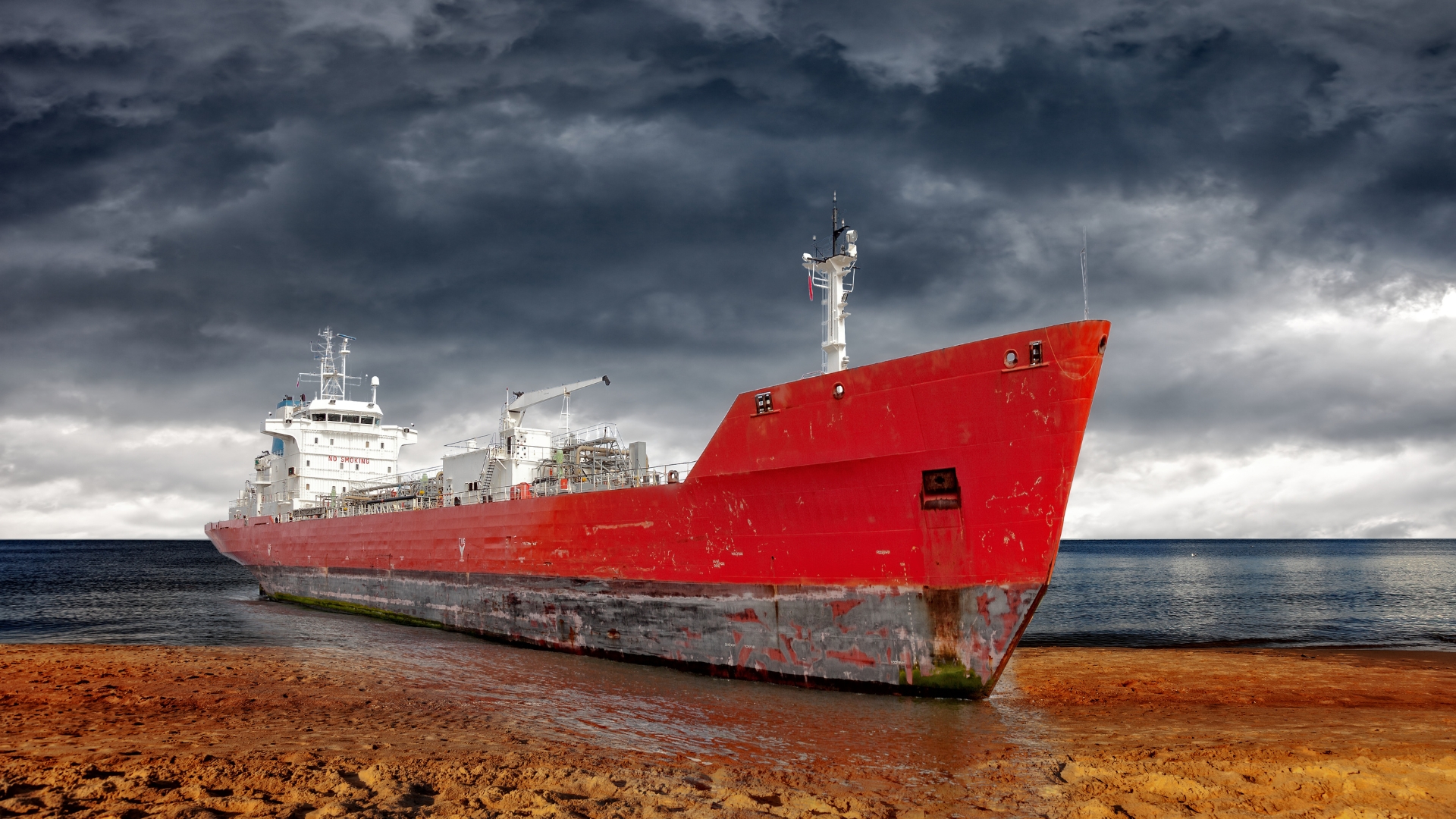 Large gantry cranes moving shipping containers at a port.