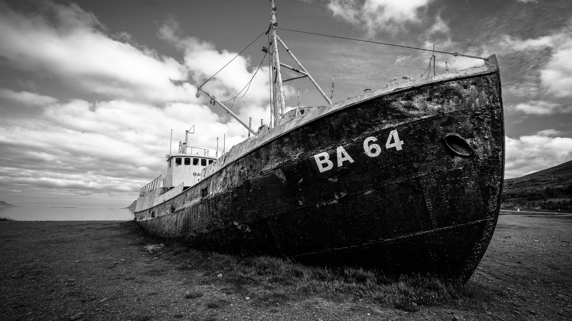 An industrial port at sunset with cranes and ships.