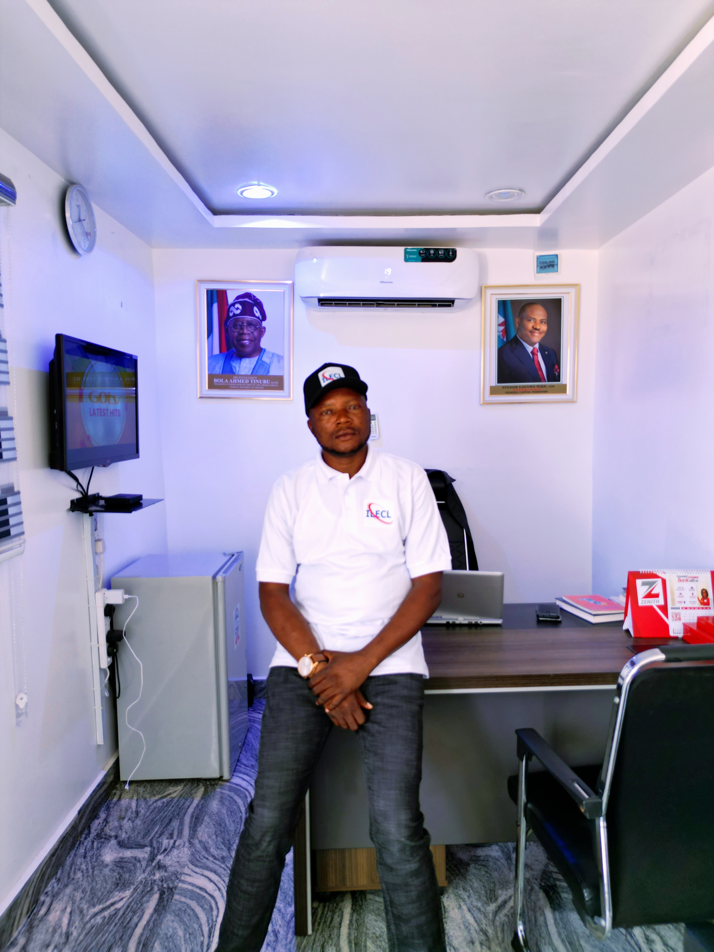 A confident male CEO in business attire, smiling warmly in a modern office setting.