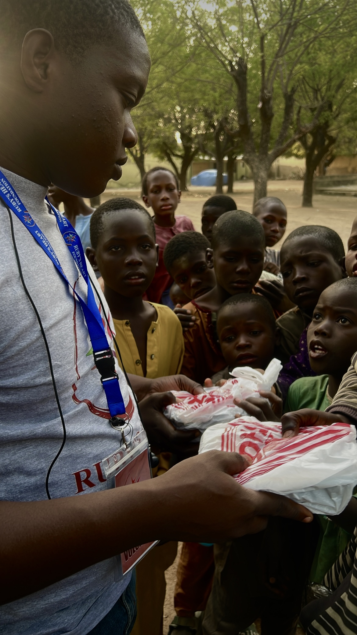 A group of happy children and adults from the community.