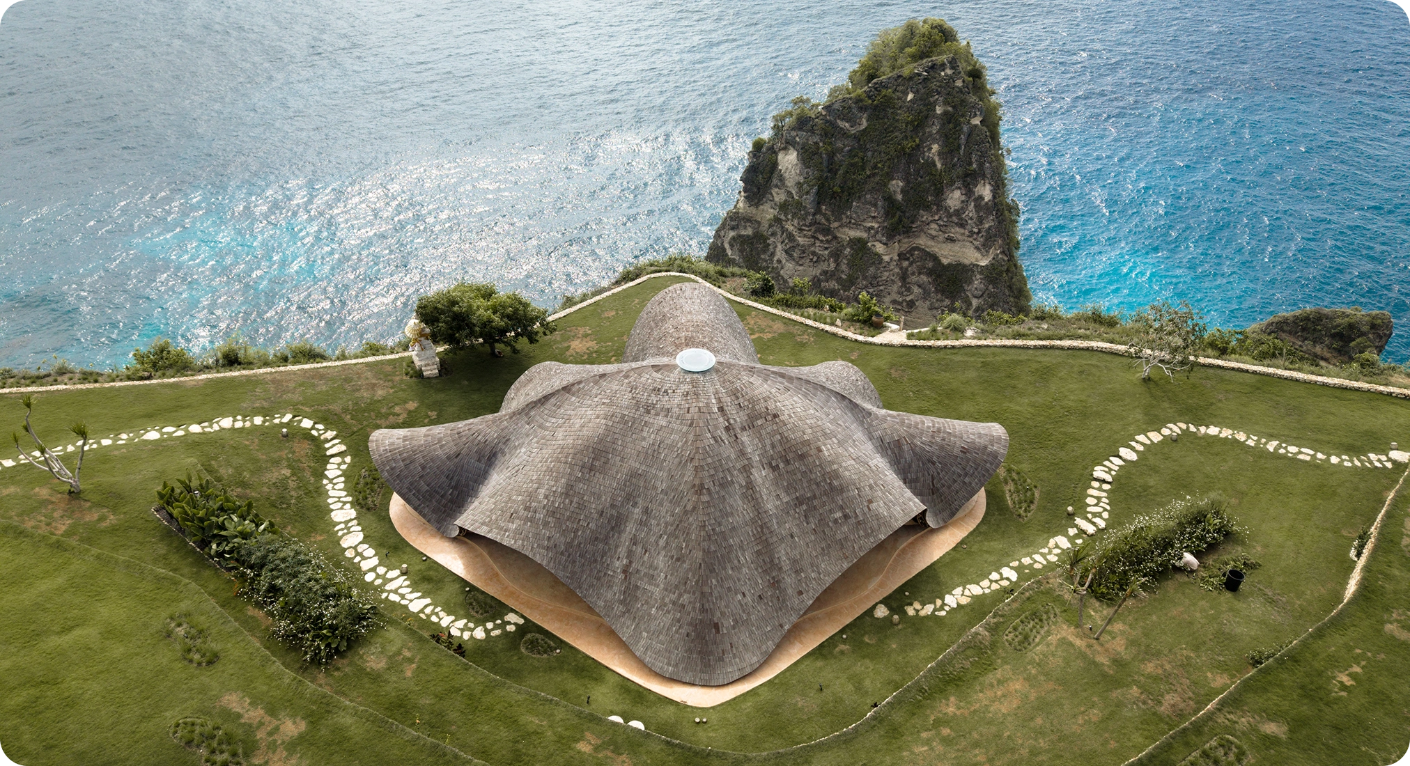 A cliffside farm on Nusa Penida overlooking the ocean, symbolizing activation and ecological design.