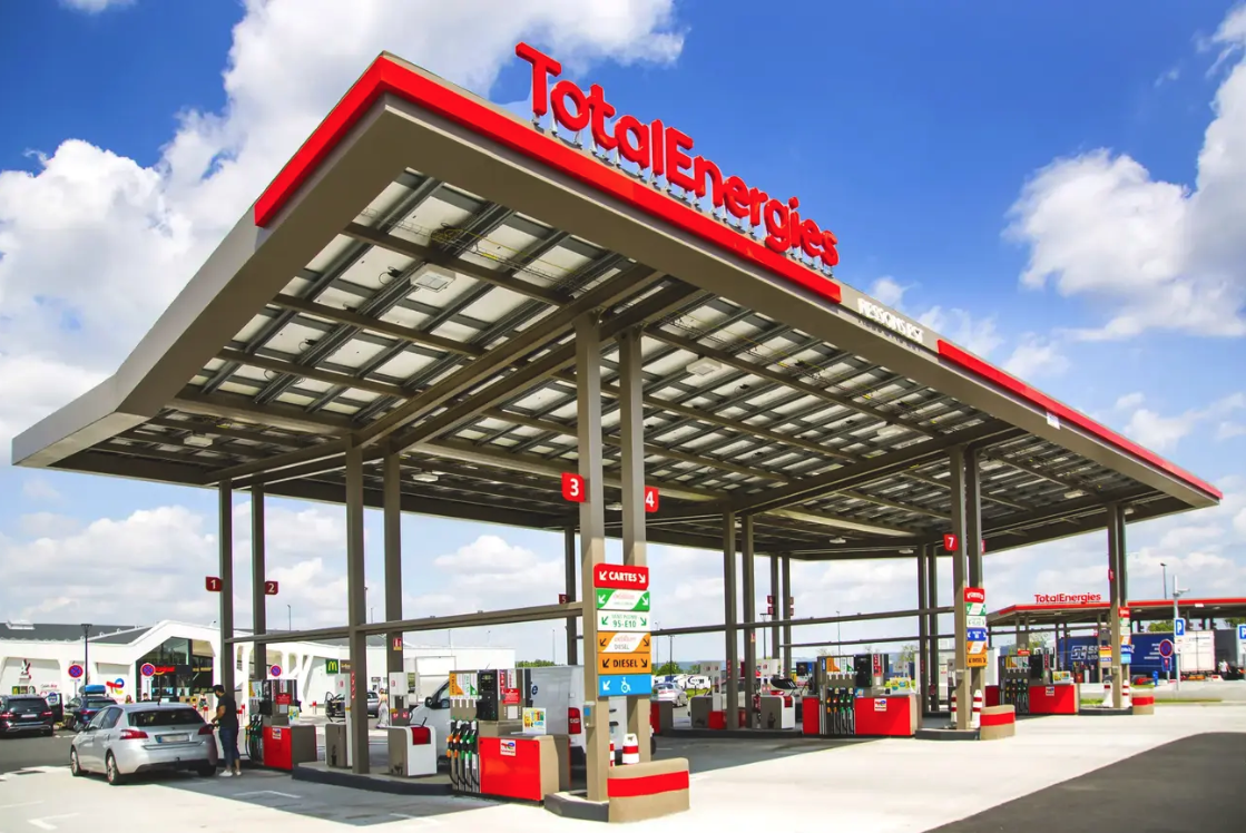 A modern wind farm with turbines against a sunset sky.