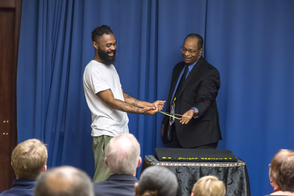 Magician performing a card trick at a corporate event.