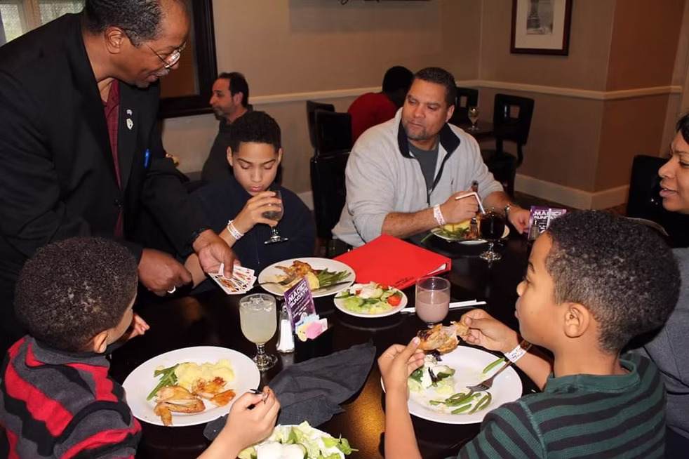 Magician performing for a group.