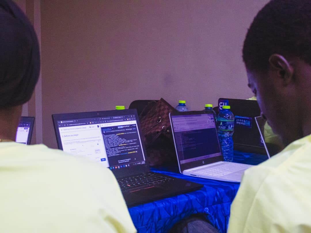 A developer working on a custom CRM dashboard interface on a laptop.
