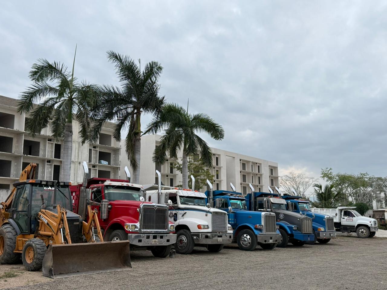 Team of workers and trucks from Transportes Sánchez JR.