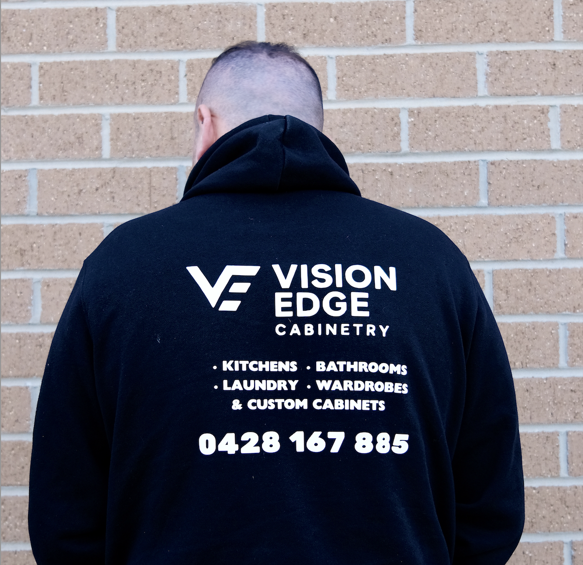 Vision Edge Cabinetry owner showing back of jumper.