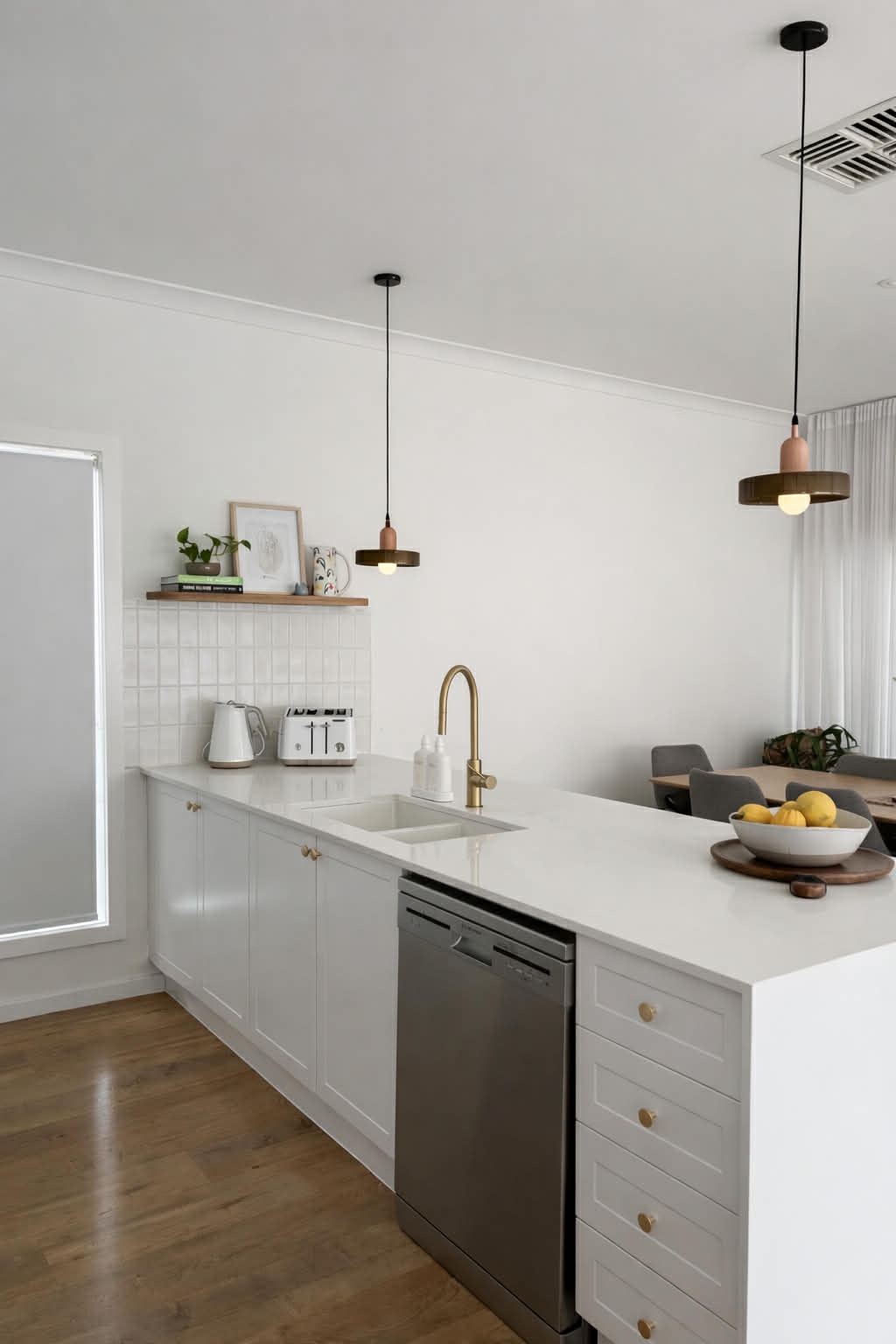 A stunning kitchen reface in Caroline Springs, featuring modern white cabinets and a clean aesthetic.