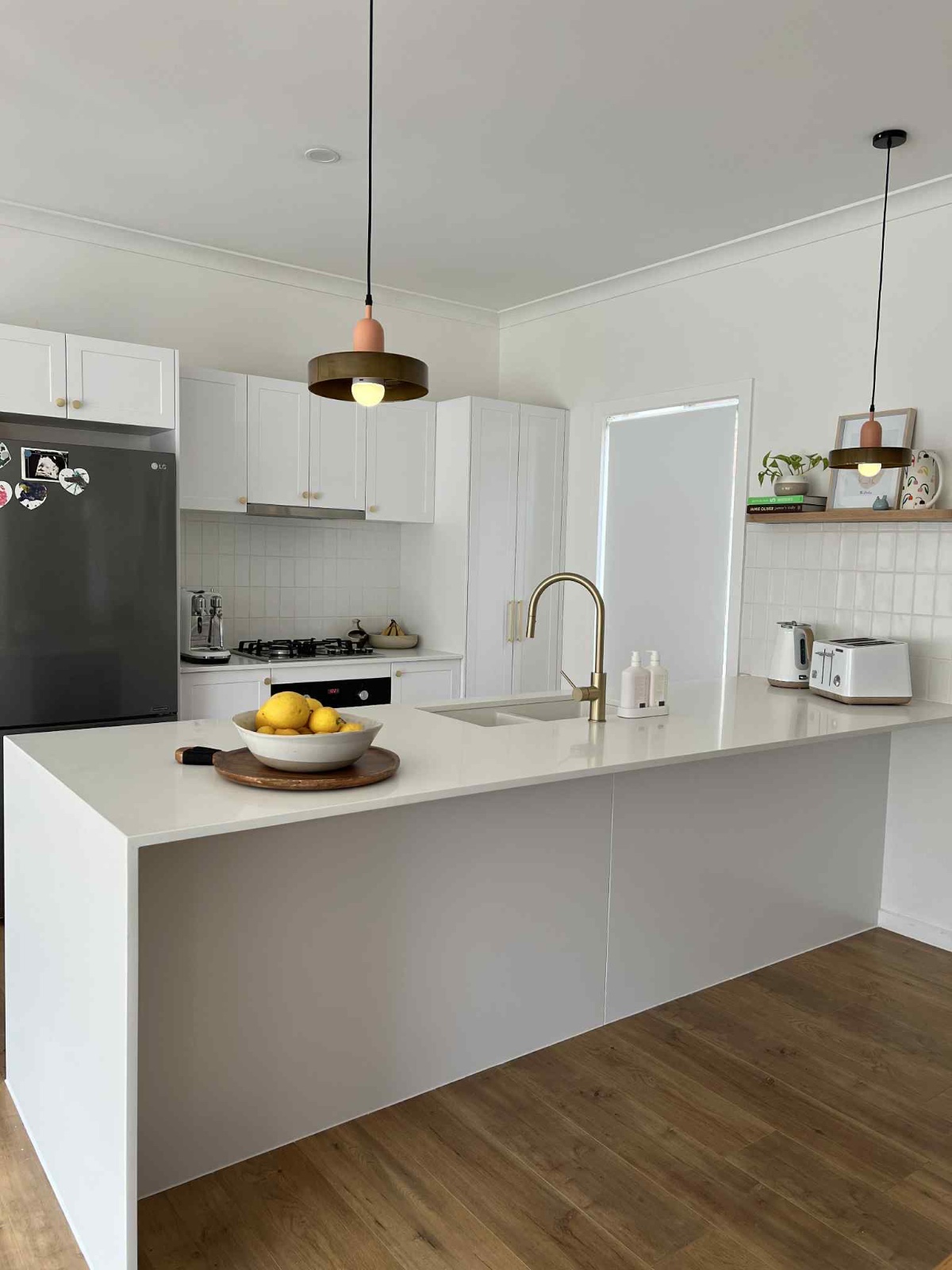 A stunning kitchen reface in Caroline Springs, featuring modern white cabinets and a clean aesthetic.