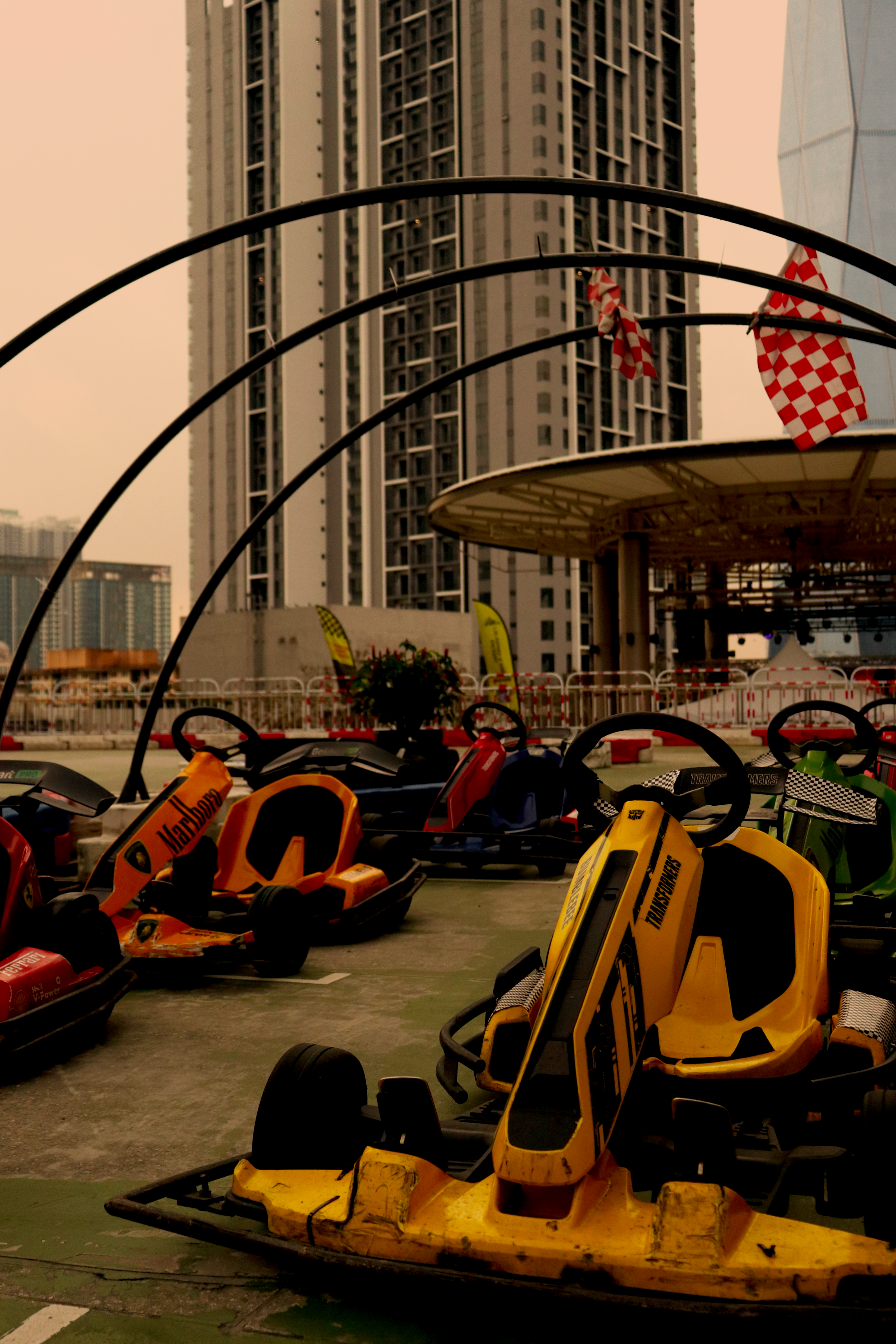 A driver posing with their kart during the day.
