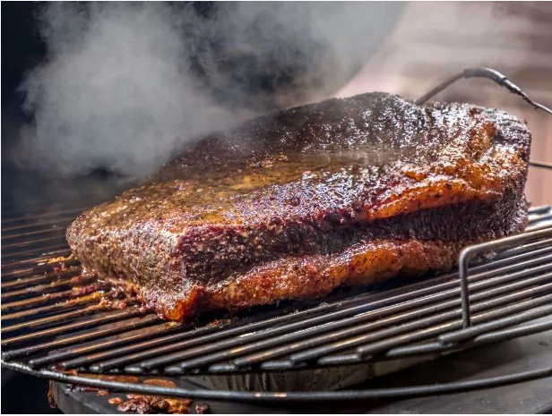 Close up of juicy sliced brisket on a wooden cutting board
