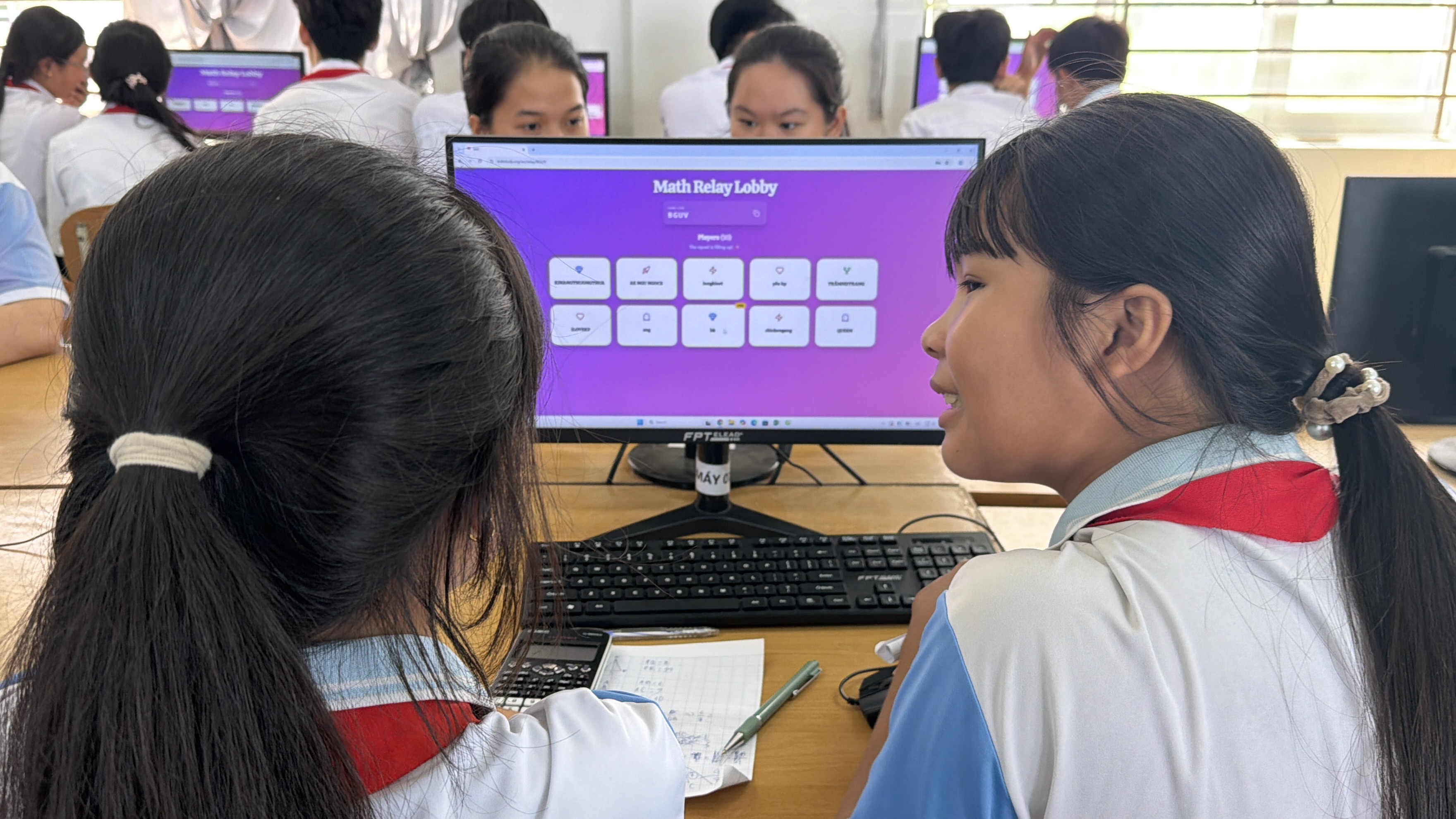 Students using the Maths4Threads platform during a classroom session.