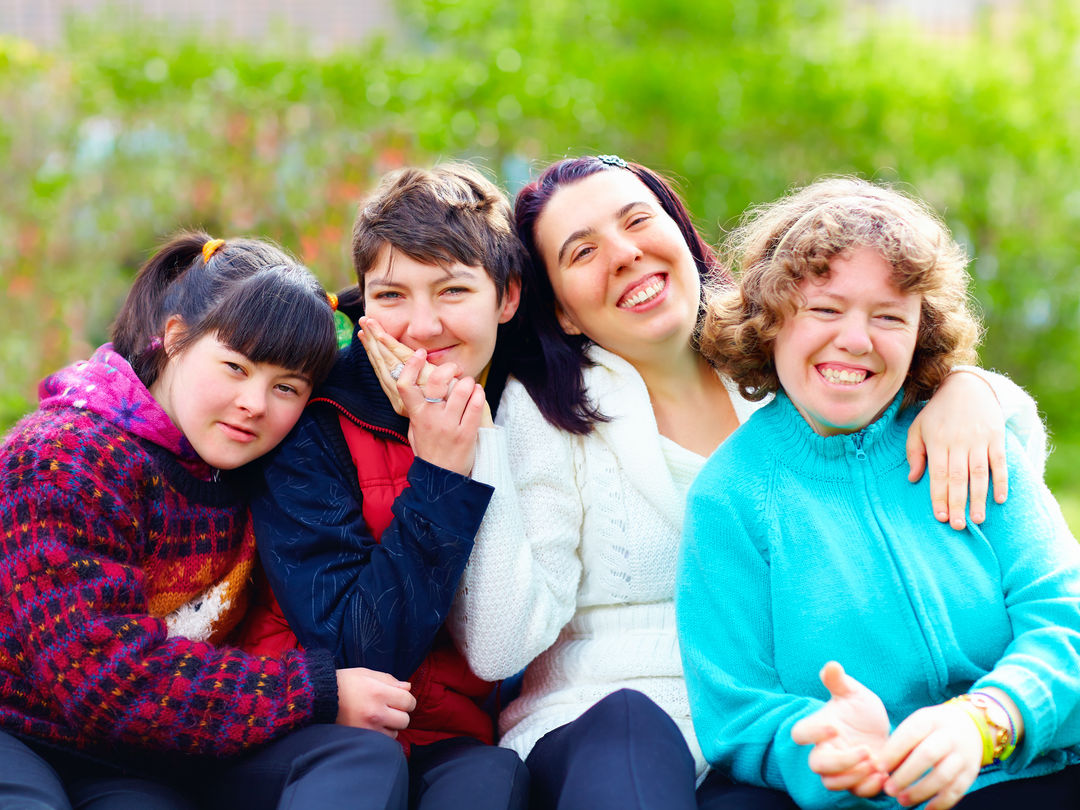 A compassionate caregiver assisting an elderly person in a bright, welcoming home environment.