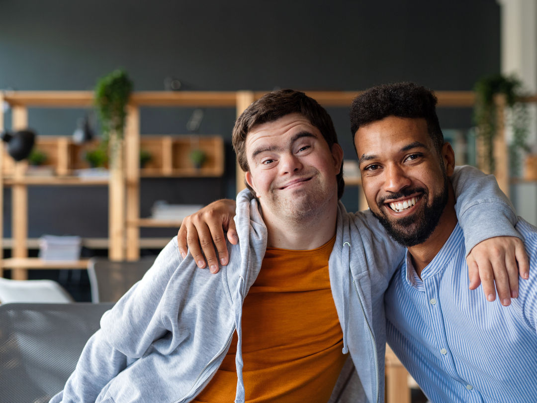 A compassionate caregiver assisting an elderly person in a bright, welcoming home environment.