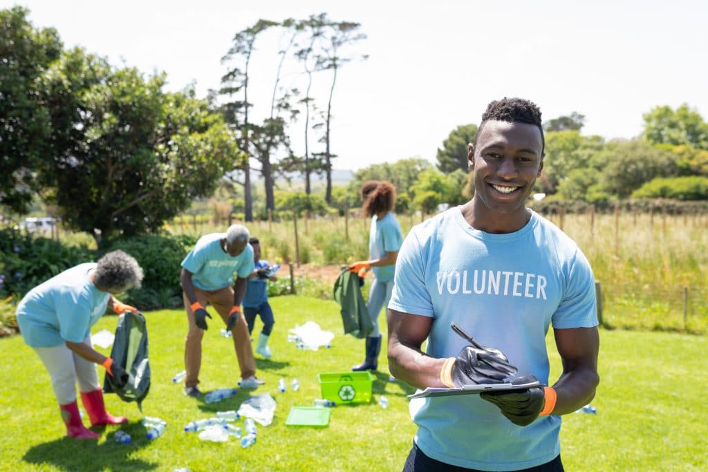A group of smiling volunteers at an event.