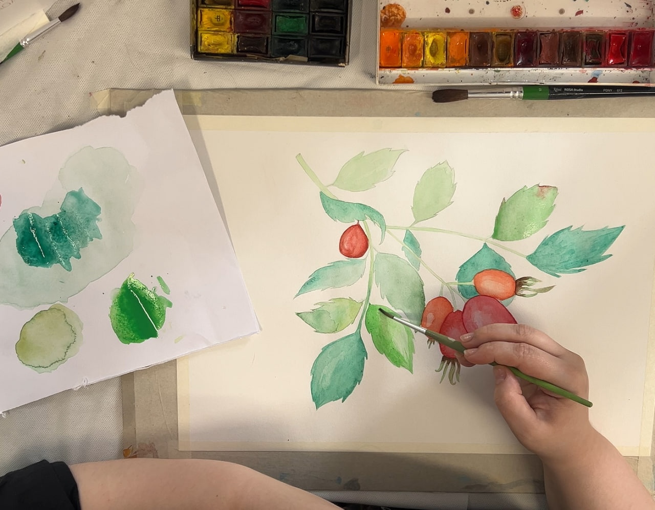 A person painting on a canvas in an art studio