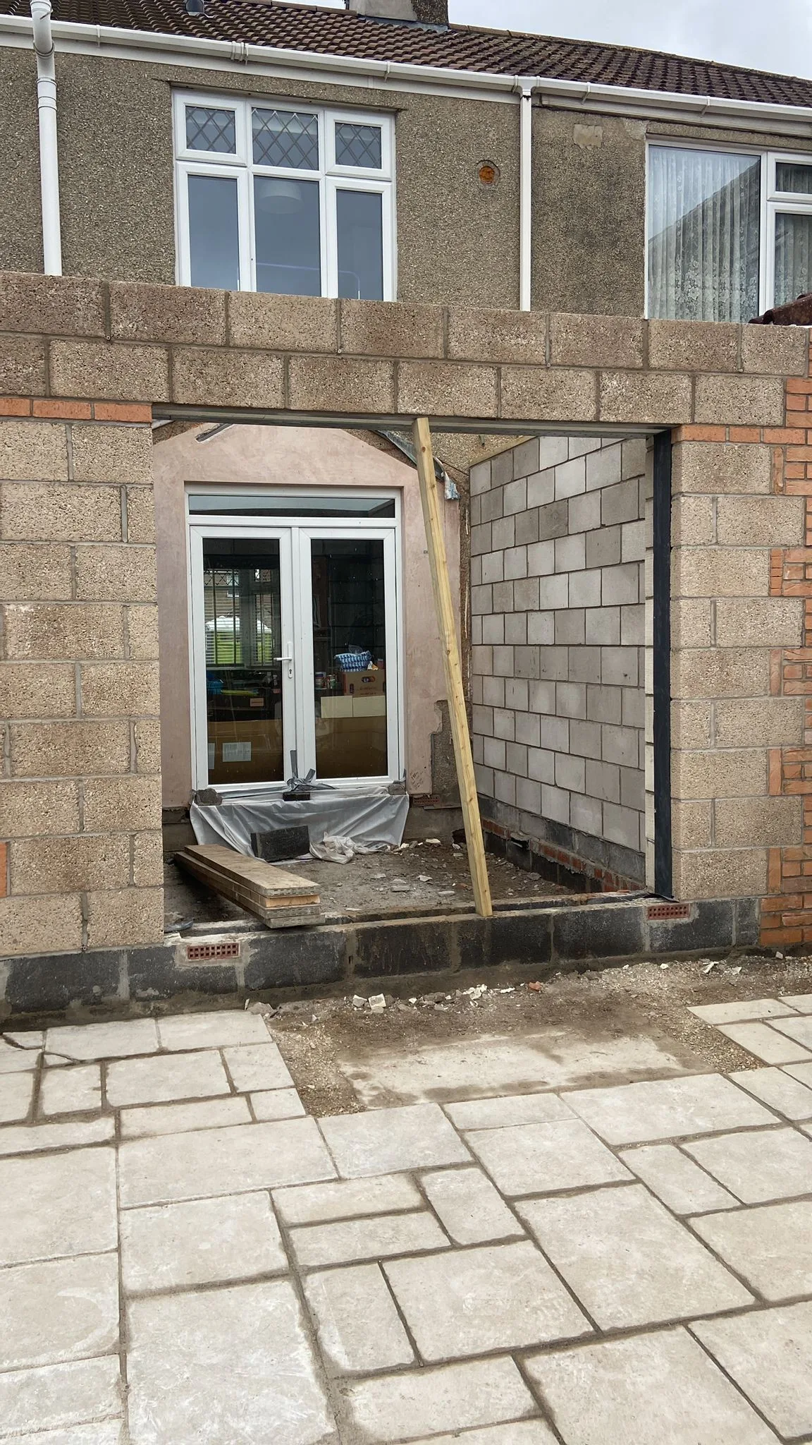 New blockwork walls of a single-storey rear extension in Kingswood with a wide opening formed