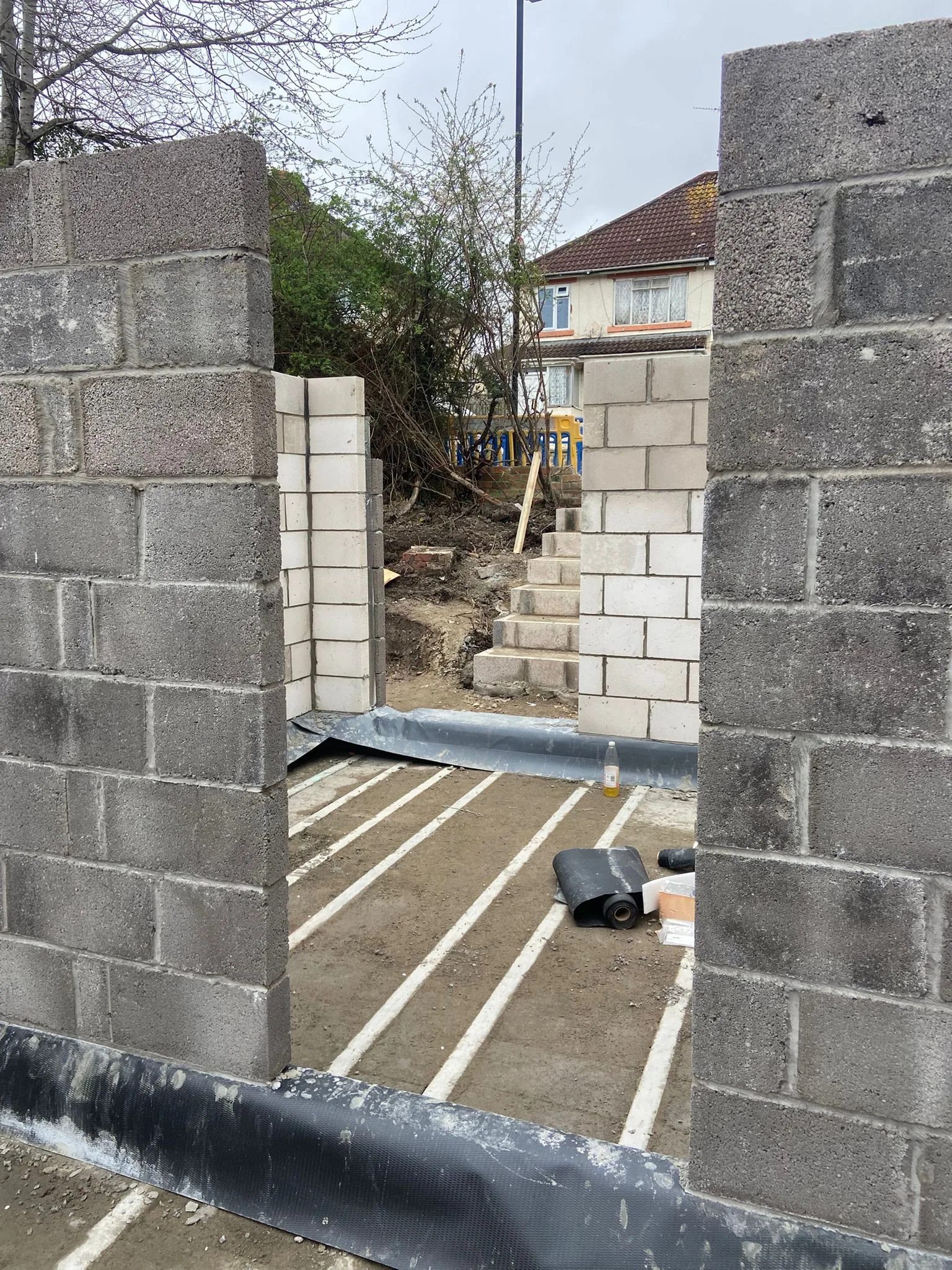 Block and beam ground floor with black damp-proof membrane at the base of new blockwork walls