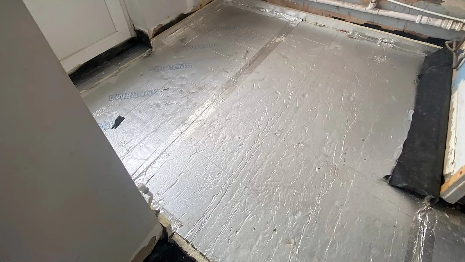 Foil-faced insulation boards over a rebuilt kitchen floor, the kind of upgrade a home energy retrofit starts with