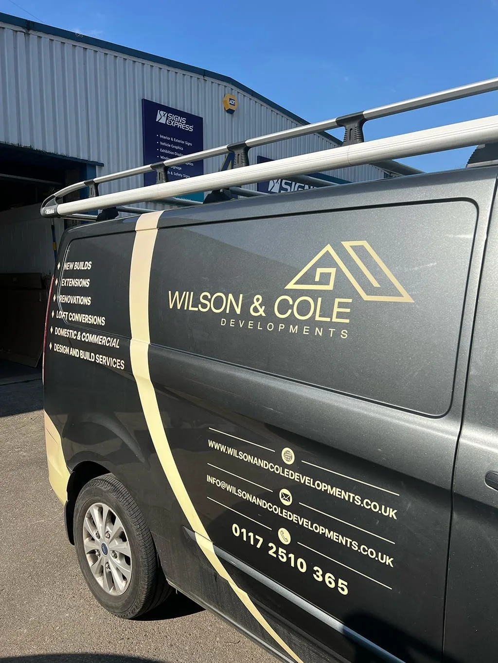 Wilson & Cole Developments van with gold livery showing the company name, website, email and phone number