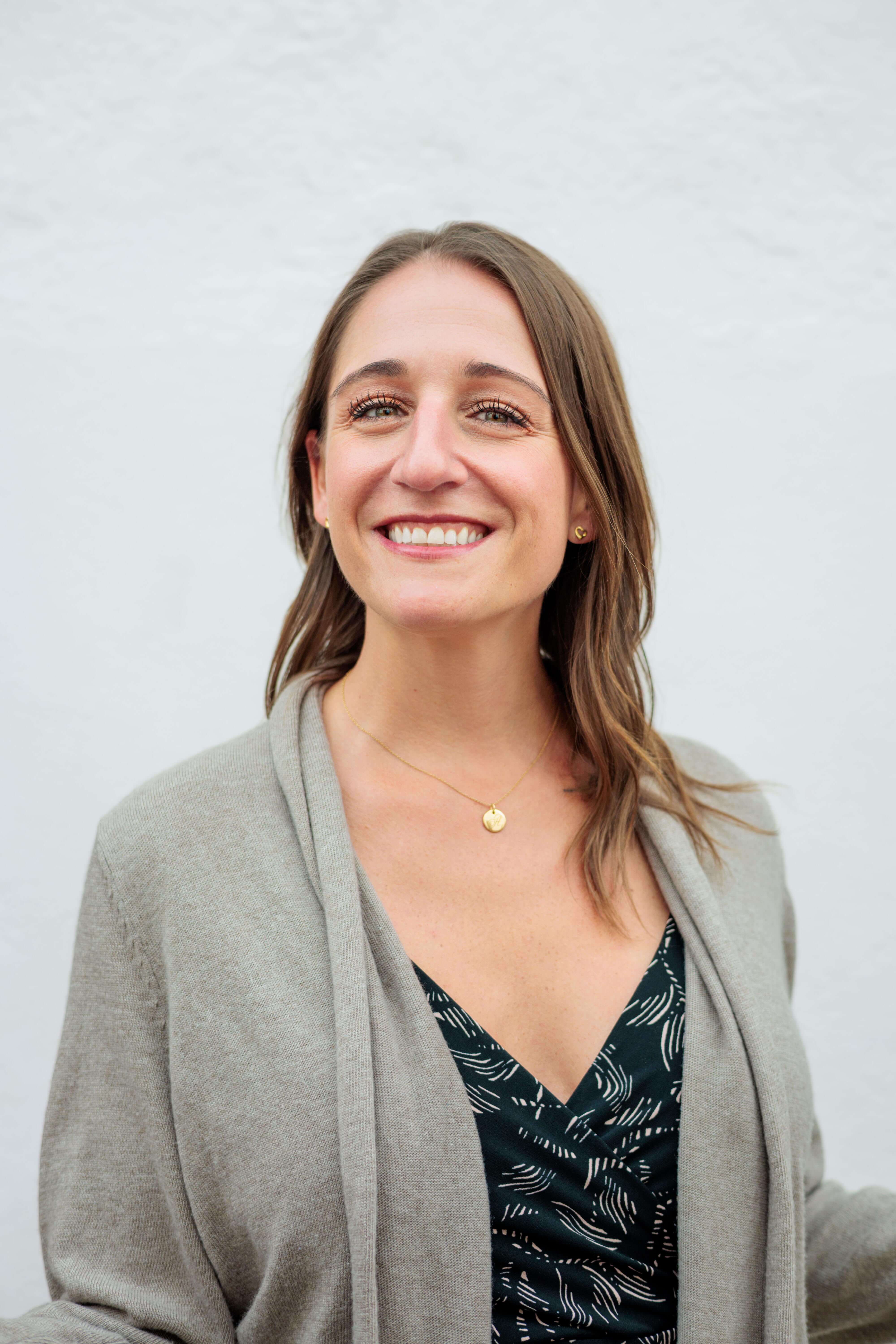 Portrait of Amber, a friendly and professional fitness trainer, smiling.