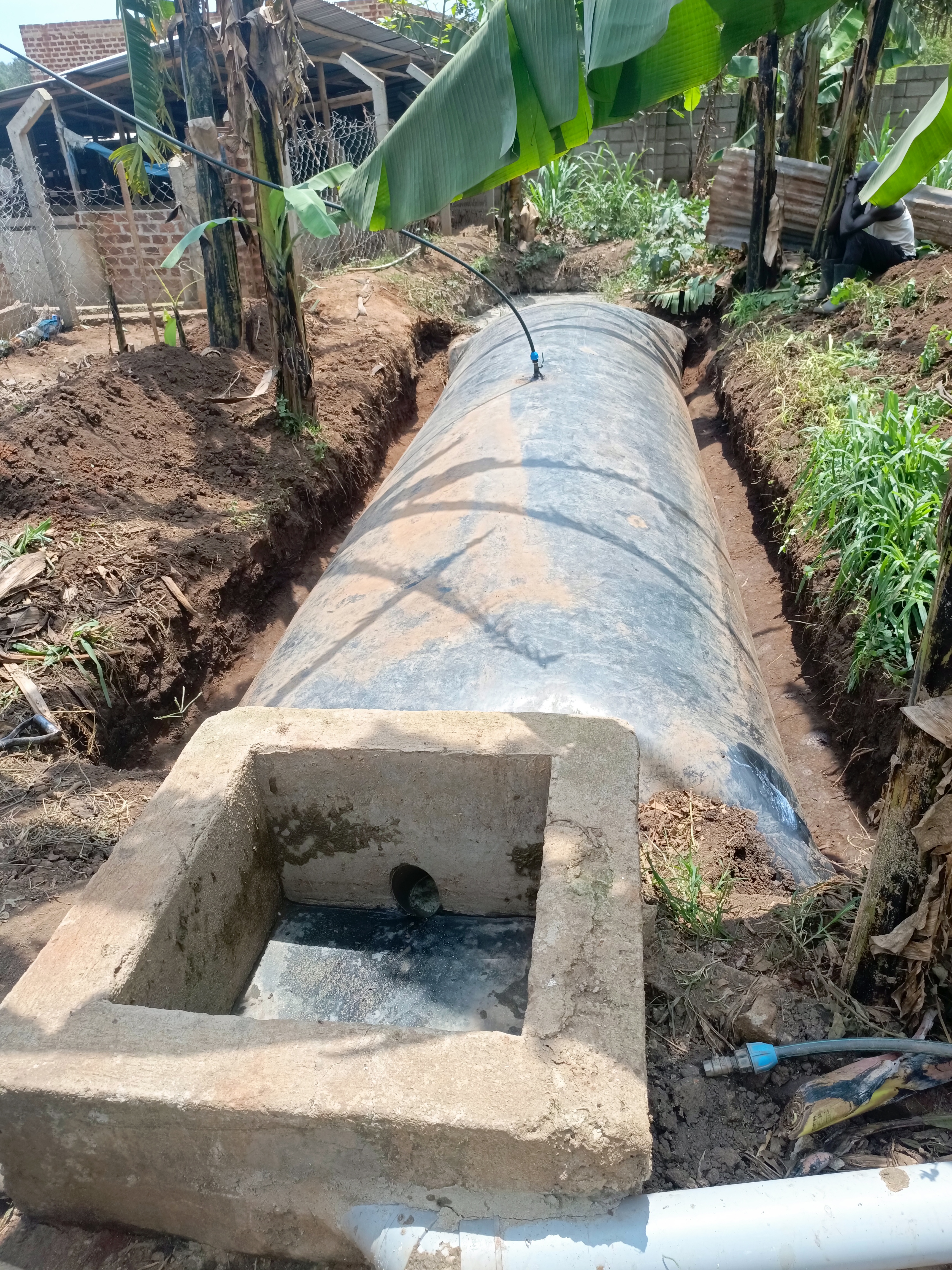 A prefabricated biogas system installed neatly next to a rural home.