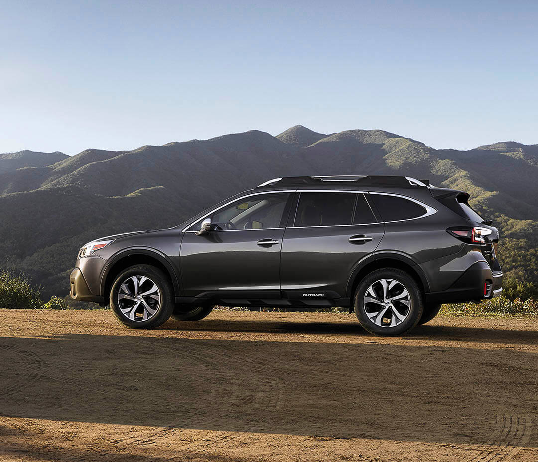 vue latérale d'un Subaru Outback Tourisme XT 2022 non loin des montagnes en nature