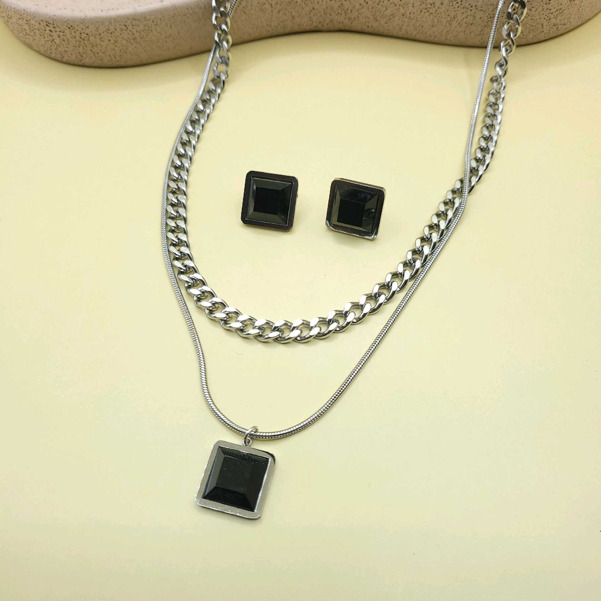 Juego doble tono plata piedras negras / acero inoxidable 