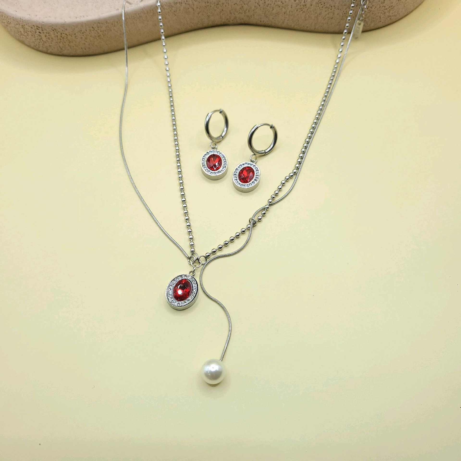 Juego tono plata piedras rojas y perla/ acero inoxidable 