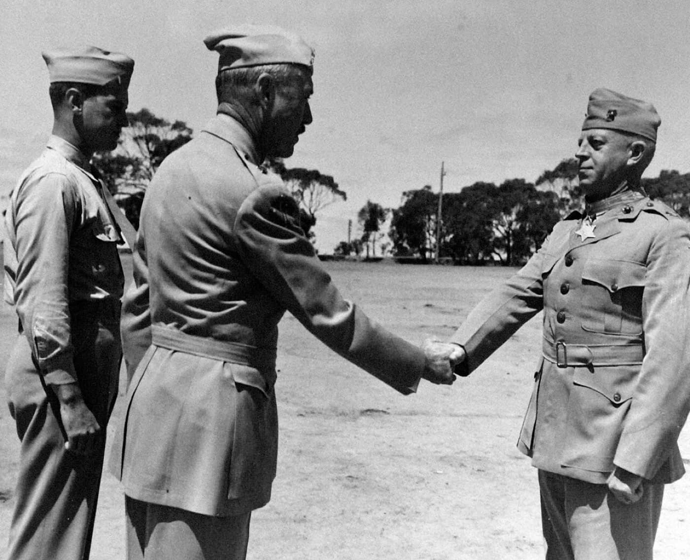 Colonel Merritt Edson, wearing the Medal of Honor, shakes hands with a general