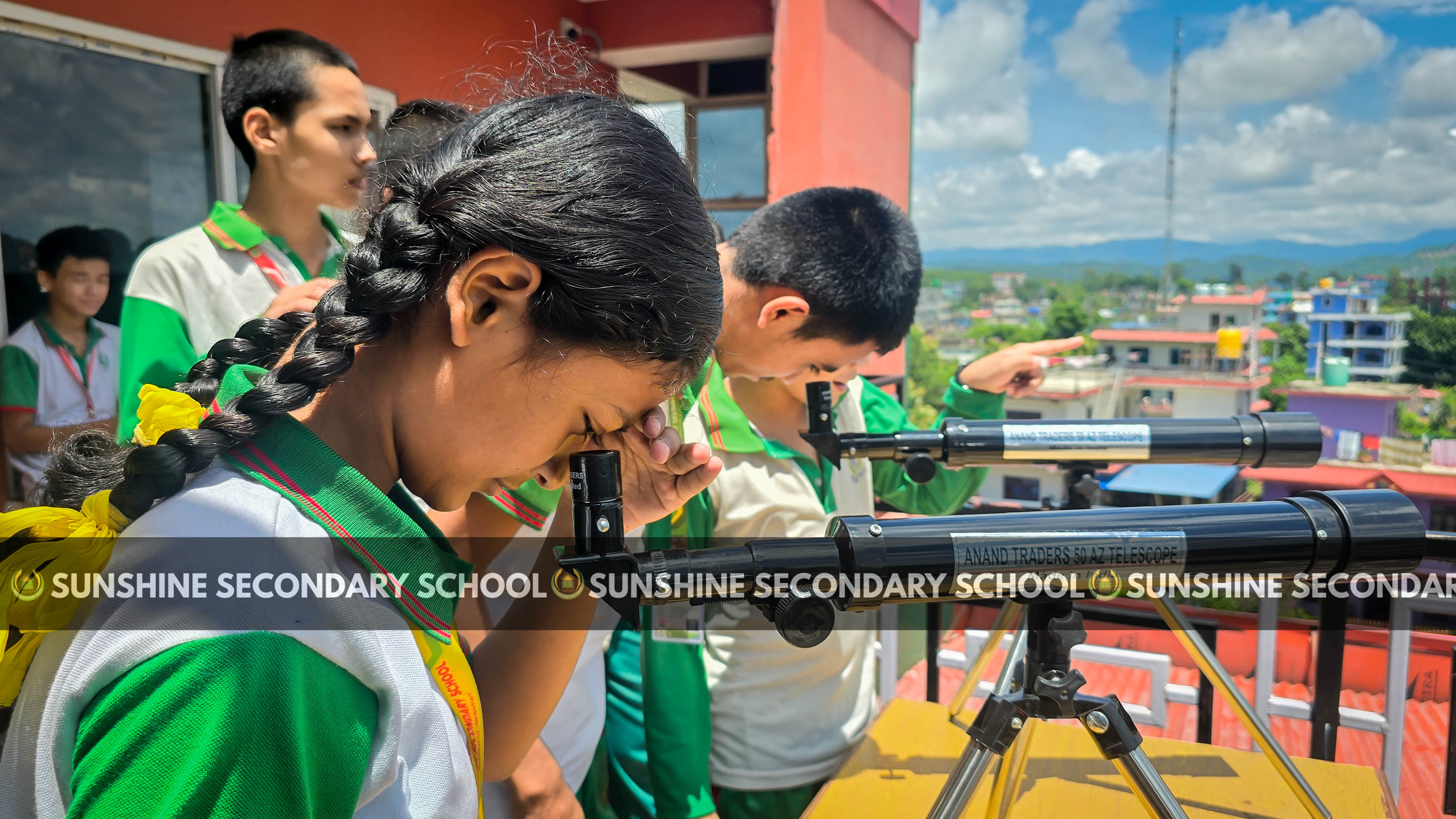 Class 8 Student exploring telescope.