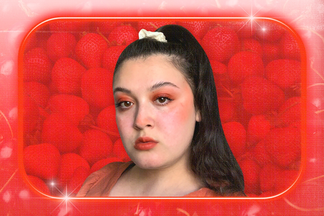 Red monochromatic makeup on strawberry background