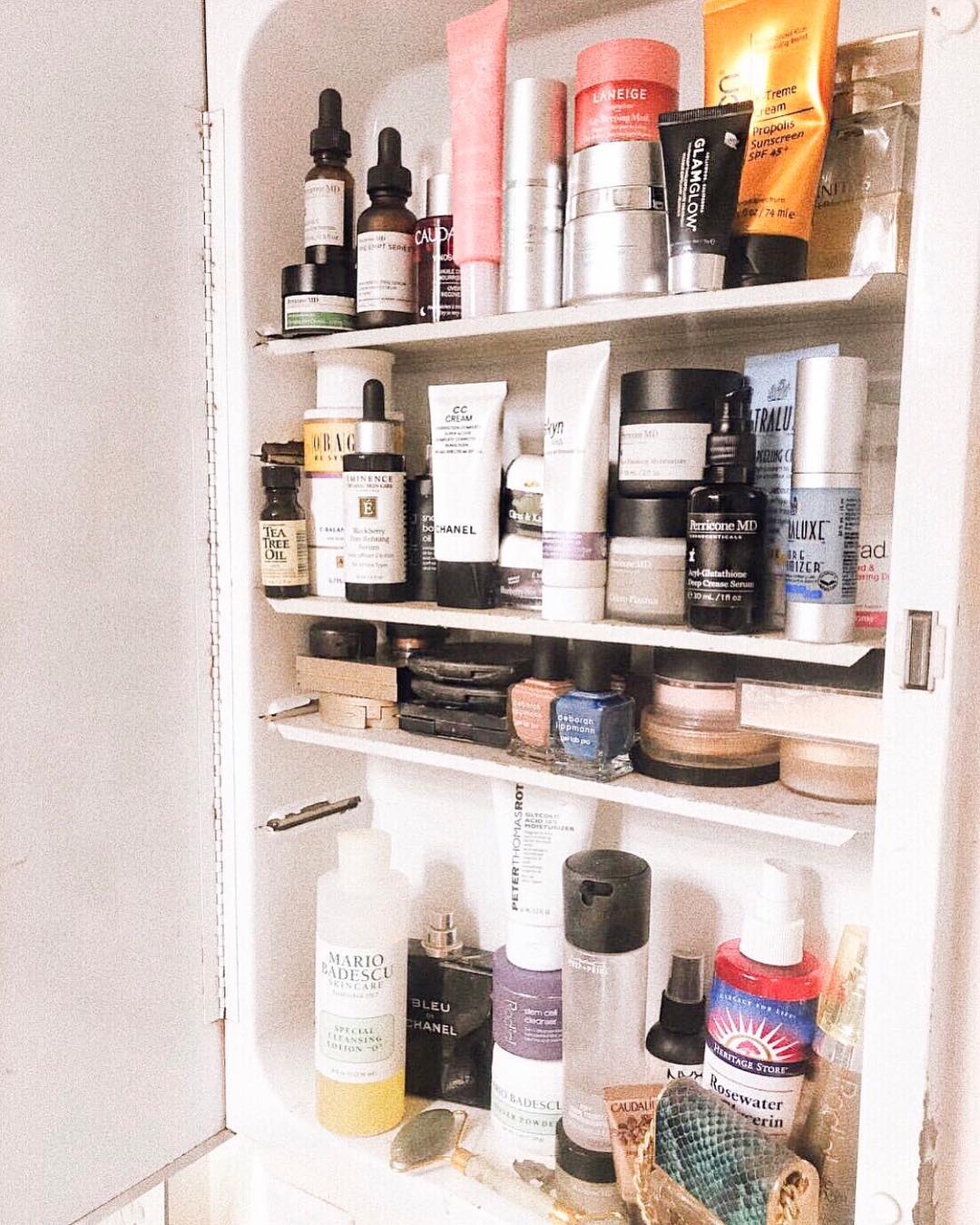 A medicine cabinet stocked full of various beauty products.