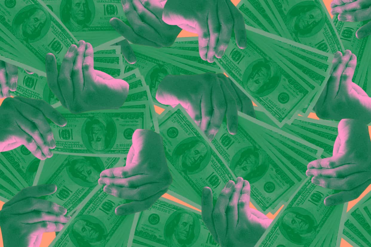 Several hands fanning out one hundred dollar bills
