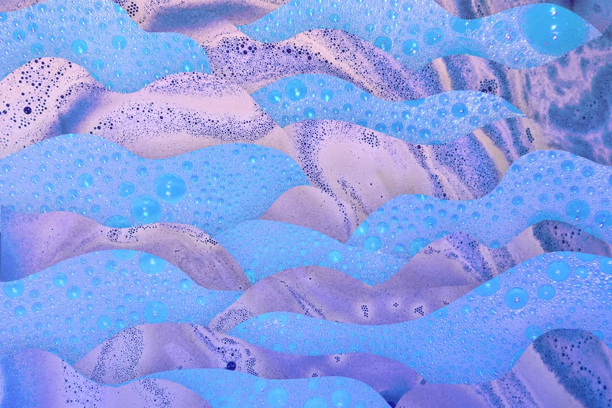 Shampoo suds and bubbles on a purple and blue background