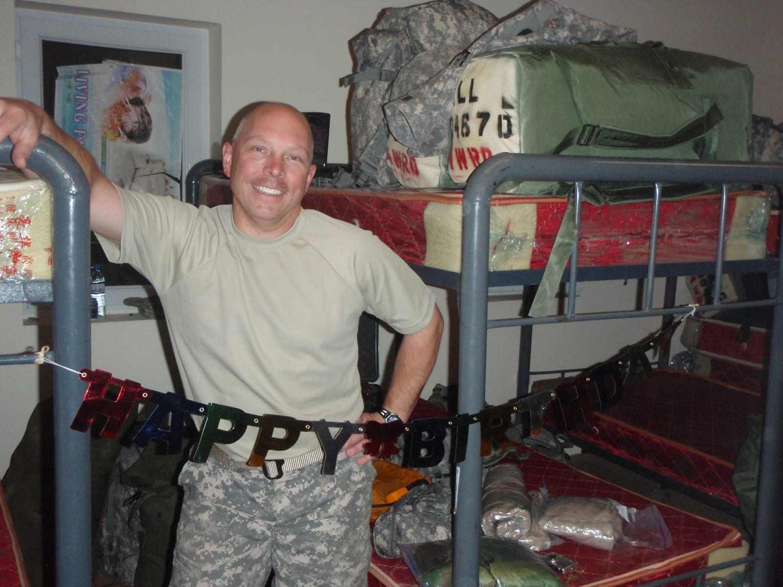 Kevin Miller behind a Happy Birthday banner