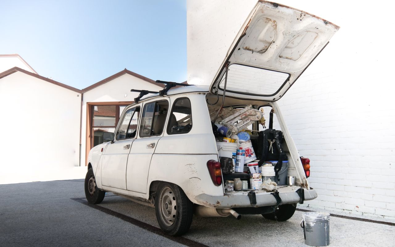 A worn van loaded with painting supplies illustrates the travel and material overhead every small job demands.