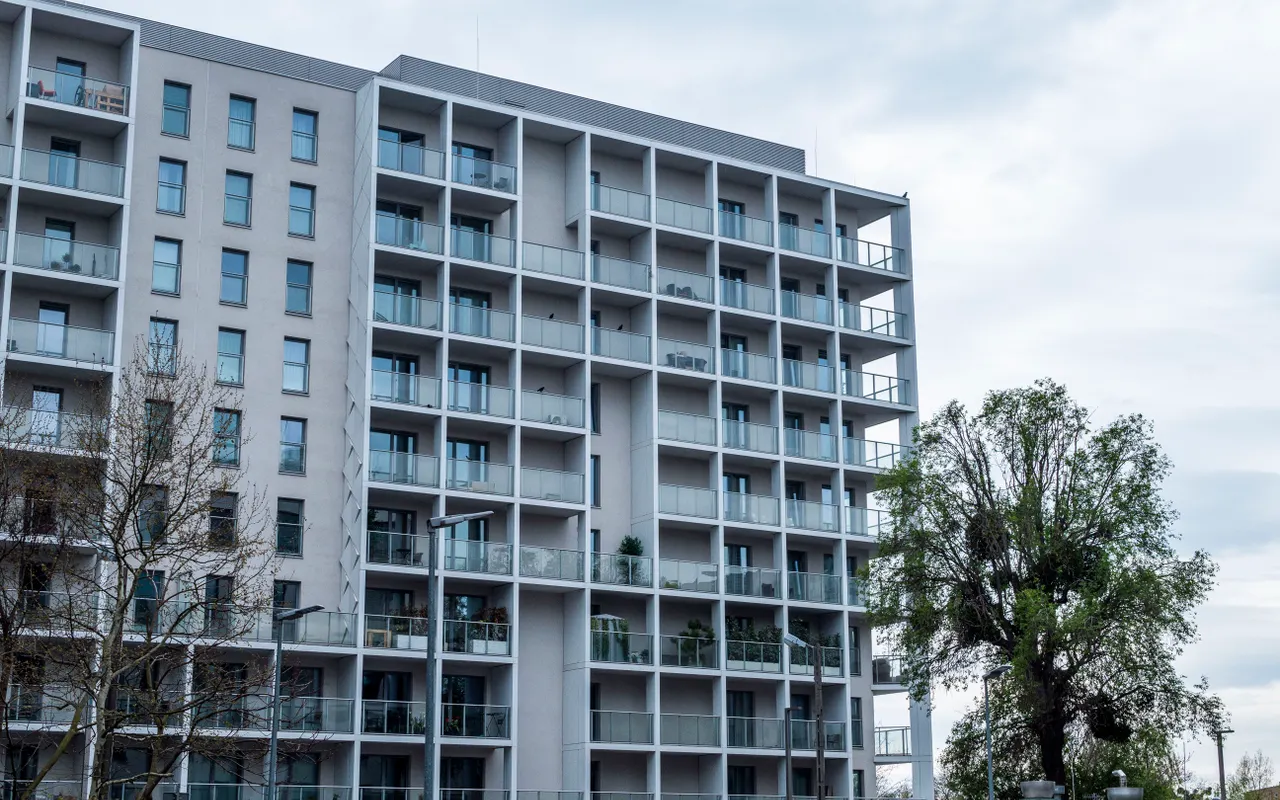 A multi-storey residential unit complex exterior — the kind of building where per-unit condition differences silently kill a lump-sum quote.