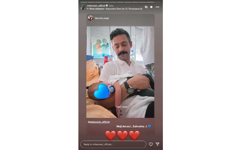 Milan Vasić drži sina u naručju
