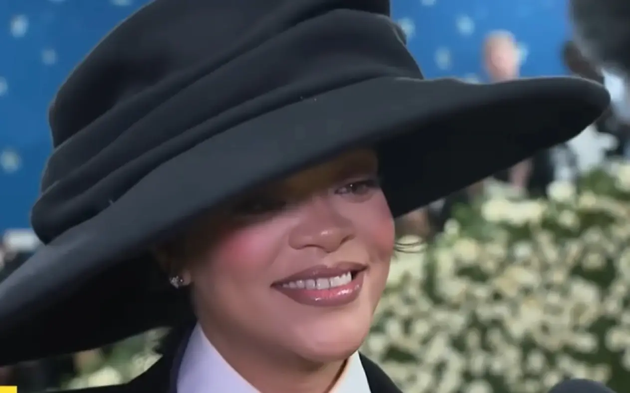 Rihanna u občena u braon kožnu jaknu sa krznom i ozbiljnim izrazom lica sluša pitanje gledalaca iz publike