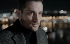 Mirza Selimović u spotu za novu pesmu Mirza Selimović u crnoj rolci i sivom kaputu zamišljenog pogleda u spotu za novu pesmu