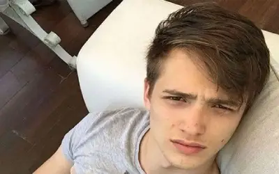 Aleksej Bjelogrlić selfie Aleksej Bjelogrlić leži u krevetu u sivoj majici sa ozbiljnim izrazom lica