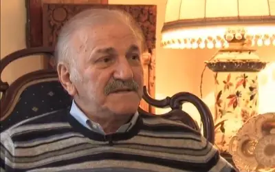 Bata Živojinović u TV emisiji Bata Živojinović u sivom džemperu i sa brkovima daje intervju u emisiji