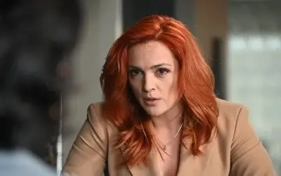 Milica Janevski scena iz serije Milica Janevski sa narandžastom kosom i bež odelom