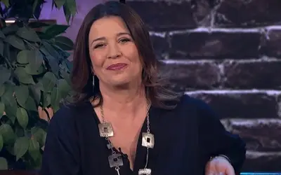 Nela Mihailović tokom gostovanja u TV emisiji Nela Mihailović u tamnoj bluzi sa osmehom na licu